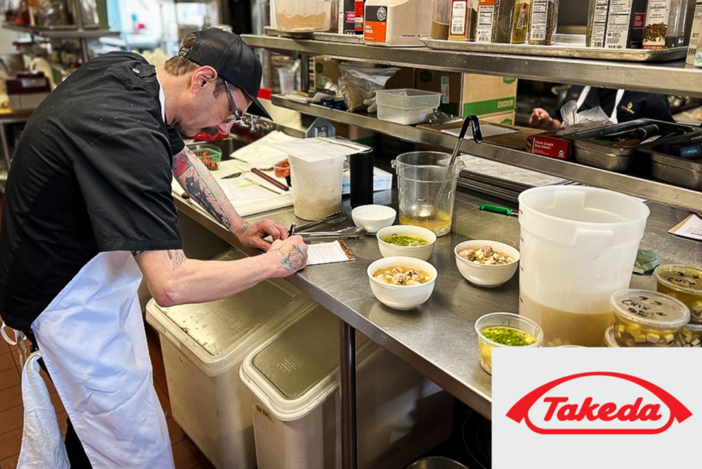 Chef Fodge working on cultural meals program in kitchen. Takeda sponsor.