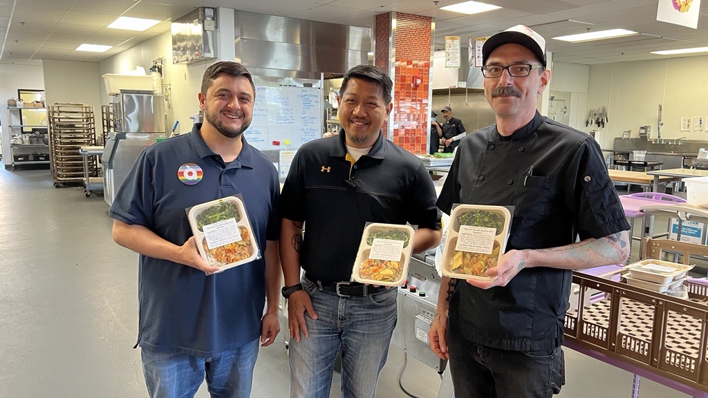 Andrew Mendez (Chief Program Officer), Stanley Hadiwibowo (Director of Food Services), and Matt Fodge (Menu Development Chef) with the first Hmong specific meals produced through Open Arms' Cultural Meals Program.
