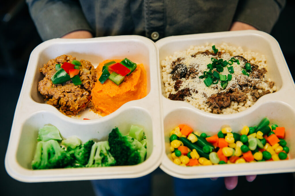 client meal trays in hands.