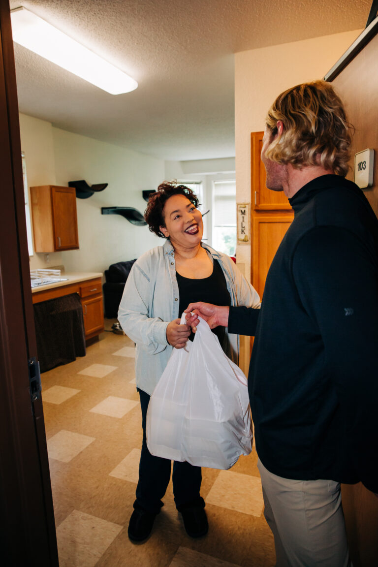 Volunteer delivers to client.