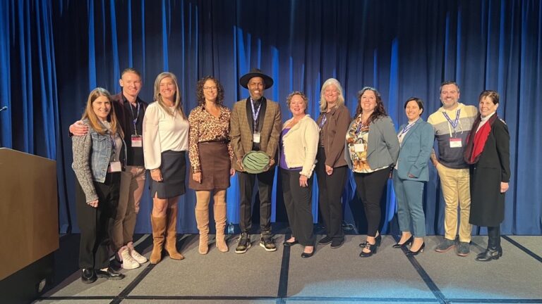 Open Arms staff accepts award for Innovation.