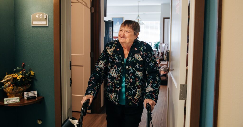 Client Phyllis, walking to door for meal delivery.